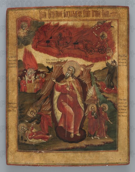 Icon: The Fiery Ascension of the Prophet Elijah into Heaven, Russian workshop. Bird iconography, icons, prophets, Elijah Bible, raven iconography, wings, horse iconography, chariot iconography, Lord of Hosts iconography, Elisha Bible, God the Father iconography, angels, inscriptions. In the center of the icon, against a mountainous landscape and a cave, the prophet Elijah is depicted full-length, seated and leaning on a staff. He turns to the left, raising his head and right hand in a gesture of blessing. To his left a raven flies downward. Scenes illustrating the saint's life are placed around the figure, while the entire upper part of the icon is occupied by the fiery chariot upon which the prophet sits. In the upper left corner the Lord of Hosts is depicted turning towards Elijah. The composition is notable for the significant enlargement of the central figure relative to the others. The icon is characterized by very elaborate design and rich colors, with a predominance of red, gree...
