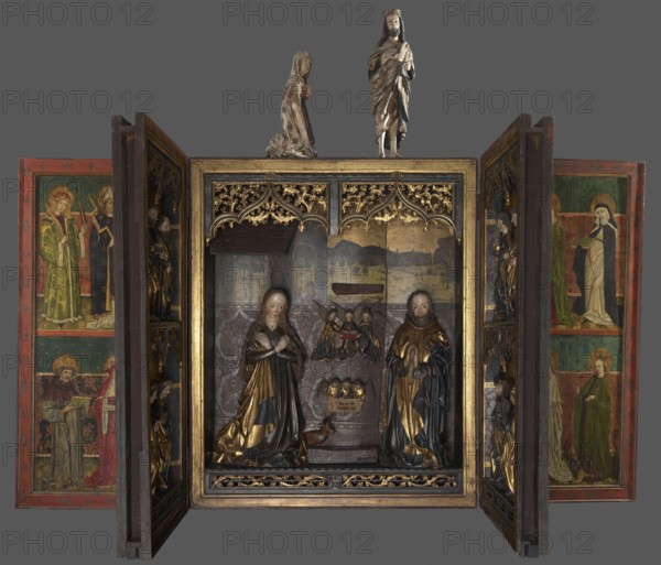 Polyptych of the Adoration of the Child, Master of the Polyptych of the Annunciation with the Unicorn, medieval painted altar retable, ca. 1470–1490 variously dated c. 1470s–1480s; inscriptions and scholarship suggest funding and work c. 1480–1484, funded by the Prockendorff/Prockendorf family mentions of Johannes/Caspar Prockendorf and absence of a daughter-in-law's coat of arms noted, subject: Adoration of the Child with St. Joseph, likely workshop participation by an apprentice for the wing figures, origin: Wroclaw St. Elizabeth's Church, altar, height 191 cm, width 314 cm, An open wooden altarpiece with carved figures and painted panels is shown against a gray background; the central shrine contains a group of carved, gilded and polychrome statues including a kneeling female figure in a dark robe with gold accents and a standing male figure in a dark garment with gold highlights, flanked by smaller carved figures and decorative gilded tracery above and below; the inner backdrop of ...
