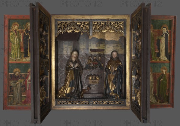 Polyptych of the Adoration of the Child, funded by the Prokendorff family, Master of the Polyptych of the Annunciation with the Unicorn creator, repossession, Prockendorf family, Joseph St., Adoration of the Child iconography, medieval art, ca. 1480 Luchs dates it to 1470–1490; Mayer attributes the figurative representations of the wings to a workshop apprentice and states the retable was funded by Johannes Prockendorf in 1480–1484—supported by the absence of his son's wife's coat of arms, who married in 1485; Brauner Wiese ca. 1470; Ziomecka suggests early 1470s; mention of foundation by Caspar Prockendorf dated 1481, Wroclaw St. Elizabeth's Church, altar, height 191 cm, width 314 cm, A carved wooden triptych with painted inner panels and sculpted central figures is pictured against a gray background, showing a central compartment framed in gold with ornate gilt tracery along the top, a patterned backdrop, and a small structure suggesting a stable; inside are two carved figures with f...