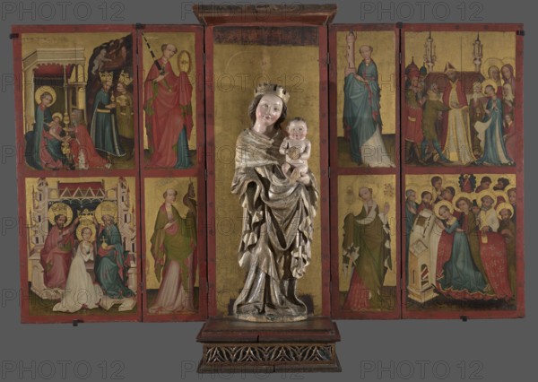Canopy altar, Gdansk painter; canopy altars; Mary mother of Jesus Christ; Gdansk Pomeranian Voivodeship; medieval art; Church of the Blessed Virgin Mary Gdansk; Sródmiescie. Carved depictions in the body; canopy central part with plinth; four wings painted on one side — the inner wings narrower, with wider outer wings attached. Each wing divided horizontally into two quarters, enclosed in a painted frame of a narrow red band decorated with schematic flowers. The figure of the Madonna currently placed in the altar does not originate from this altar. Colours: vestments — predominance of light colours; reds with cool shades, light blue, olive green modeled with yellow, white, pink broken with purple. Flesh complexions modeled with warm pink and brown. Architecture in pink and white with accents of red and blue; green ground stripe. Haloes, robes' frames, crowns — gold. Gold plain background. Red frames with gilded, rosettes. Dated ca. 1430 various scholarly datings ca. 1410–after 1420, so...
