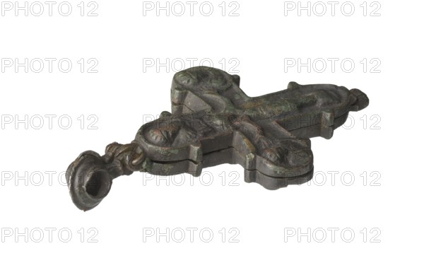 Enkolpion, Ruthenian workshop; bipartite enkolpion in the form of a Greek cross arms straight, not widening with side and upper arms terminating in medallions; side medallions separated from arms by projections teardrops and a semicircular strip; upper and lower medallions marked by projections teardrops at their bases; external outline of the obverse emphasized by a raised edge. Hinges at top and bottom; bead at top. Obverse: central crucified Christ wearing a long, wide perizonium; cruciform halo and titulus above; head turned to the right; braid of hair on Christ’s left shoulder; very large hands encroaching on medallion; feet on a suppedaneum; side and upper medallions with half-figures of saints facing frontally—upper medallion possibly Pantocrator or an archangel, left medallion Mary, right medallion St. John; neither vertical nor horizontal beam of the cross is visible. Reverse: central standing Mother of God holding the youthful Christ Hodegetria; side and upper medallions with...