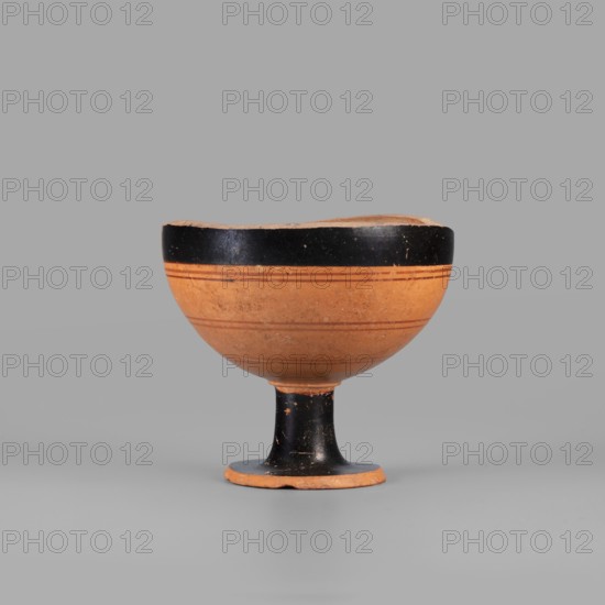 Fragment of a lydion, Archaic period. Fragmentarily preserved lydion foot and lower part of the body. The foot is flat, disc-shaped, conically recessed at the bottom in the middle. The medium-high, cylindrical foot tapers slightly towards the bowl. The preserved part of the bowl is hemispherical. The top of the foot, the foot, and the upper parts of the bowl are covered with a glossy varnish; remaining parts are clay-colored. The outer surface of the bowl is decorated with four horizontally arranged thin lines in light brown. The interior of the bowl is not smoothed, with visible traces of turning. The outer part of the foot is covered with matte varnish. Varnish color: 10 YR 2/1 black. Ornament colors: 2.5 YR 4/3 reddish brown; 2.5 YR 4/6 red. Clay color: 5 YR 6/6 reddish yellow. Provenance: Asia Minor possibly Lydia. Type: vessel, lydion. Dated by analogy to the mid–late 6th century BC c. 550–525 BC. Dimensions: height 7 cm, width 7.7 cm, weight 0.132 kg., A shallow bowl on a short s...