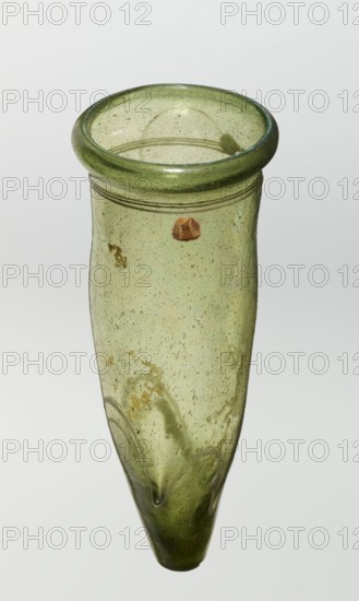 Lamp oil container, deposit provenance, Islamic art, Arabic culture, glass oil lamp, cream enamel thread also at the bottom, 12th–15th century, Syria, Egypt, Middle East, height 12.0 cm, diameter 5.2 cm, A translucent green glass vessel with a rounded rim and a tapered pointed bottom, showing a few surface bubbles and a few areas of darker green and yellowish discoloration, with a thin raised horizontal band near the top and a subtle wavy applied decoration near the lower section; the background is a plain light gray.