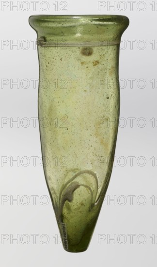 Lamp oil container, deposit; Islamic art, Arabic culture; glass oil lamp with cream enamel thread also at the bottom; 12th–15th century; Syria /Egypt, — Middle East; height 12.0 cm, diameter 5.2 cm., A translucent green glass vessel with a slightly flared rim and a narrow tapered body, showing many small air bubbles and a few darker specks within the glass; the surface has some irregularities and a faint cloudy texture, and a swirl of thicker glass detail is visible near the lower portion; background is a smooth light gray.