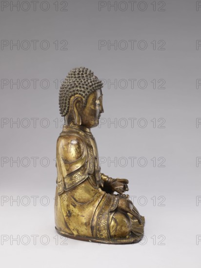 Buddha, deposit provenance, militia deposit, Chinese, Qing 1644–1911, Qing style, sculpture, casting, Chinese Buddhism, Buddhist art, Ushnisha, 19th century, China, figurine; height 32.0 cm, width 23.5 cm, weight 6.255 kg, A seated bronze statue of a figure viewed in profile with a textured hair surface, elongated earlobe, and serene facial features, wearing layered robes with decorative borders and floral patterns, hands resting in the lap in a meditative gesture, sitting on a simple base; visible colors include gold, dark brown, and shades of gray in the background.