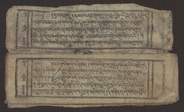 Buddhist text - Formula of repentance Tib. sdig bshags gser gyi spu gri bzhugs so, Buddhist art, Tibetan, graphic prints, Book in the Tibetan pecha style, xylographic print in the disciple script dbu can, 16 folios, folio numbering 2-15 recto, first verso, print on thin handmade paper with clear translucency, 19th century, Tibet, graphic, width 25.5 cm, height 7.8 cm, A worn rectangular sheet with a dark background shows two horizontal panels framed by double-lined borders, each panel containing densely written black calligraphic strokes arranged in horizontal lines; the paper is a yellowed beige with areas of darker brown staining and smudging, and there are creases, small tears, and roughened edges especially at the corners. A narrow vertical column appears at the left side of each panel separated by a thin line, and small dark ink spots and blotches are visible near the center fold. The overall palette includes beige, dark brown, black, and hints of gray, with the texture appearing ...