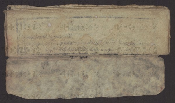 Buddhist text - Formula of repentance Tib. sdig bshags gser gyi spu gri bzhugs so. Buddhist art, Tibetan. Book in the Tibetan pecha style; xylographic print in the disciple script dbu can. 16 folios; folio numbering 2-15 recto, first verso. Print on thin handmade paper, clear translucency. 19th century, Tibet. Graphic. Width 25.5 cm; height 7.8 cm., An aged, folded sheet of paper or parchment lies against a dark background, showing a top flap with a textured, yellowed surface and a lower flap with a mottled, fibrous appearance; the top area has several faint smudges and darker grayish marks, a few small round discolorations, and subtle worn edges while the lower area displays cloudy gray, beige, and brown variations with visible fiber patterns and slightly rounded corners, and the entire object exhibits signs of creasing and uneven margins.