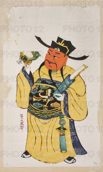 Menshen Gate Guardian, nianhua New Year's picture, early 20th century, China; graphic print; height 39.0 cm, width 25.5 cm; Chinese art; Menshen Gate Guardian iconography., A painted figure wearing a large black hat with yellow trim and a long yellow robe decorated with pale swirl patterns stands against a light beige background; the figure has an orange-red face with black facial hair and holds a green and gold ornamental object in one hand while the other hand rests near a rectangular white object, and the robe and chest area feature detailed designs in black, green, blue, and gold with a hanging green-blue tassel accessory, while a few areas of the background and edges show darker beige and brown staining.