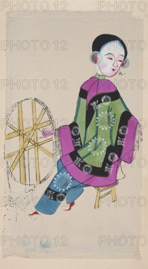 Young woman working with a spinning wheel; nianhua New Year's picture, early 20th century; Chinese; Mianzhu; graphic print; height 46.0 cm, width 25.5 cm;, A seated figure wearing a colorful layered garment in shades of green, purple, blue, black, white, pink, red, and yellow is shown against a pale beige background; the figure has a pale face with black hair and round ear coverings in blue and pink, a stylized facial expression, and a pale neck collar; the garment features floral motifs and dark bands with circular patterns, and the lower clothing includes blue trousers and red shoes; the figure sits on a simple yellow stool beside a circular wooden spinning wheel drawn in yellow and black lines.