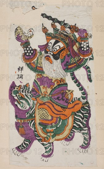 Menshen Gate Guardian, unknown artist, nianhua New Year's picture, depicted as a warrior riding a tiger, tiger imagery, guardian figure, Chinese art, graphic print, early 20th century, Fengxiang, height 44.0 cm, width 23.5 cm, A colorful painted figure wearing an elaborate headdress and ornate armor stands atop a striped feline creature. The figure has a long white beard and a stark black-and-white face pattern with orange facial details, and holds a patterned object in one gloved hand while the other hand grasps a decorative staff. The headdress and garments show rich greens, purples, oranges, and black with intricate patterns and layered fabrics, including scalloped and scale-like motifs. The feline has bold black-and-white stripes with purple areas on its body and green and orange decorative saddle elements. The background is a pale neutral paper with a slightly textured, worn appearance and a few small areas of torn or creased edges.