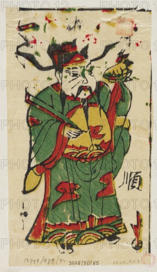 Menshen Gate Guardian, nianhua New Year’s picture, woodblock/graphic print, Chinese, early 20th century; depicts a Gate Guardian as a dignitary; Lingbao place of origin; height 18.0 cm, width 10.5 cm., A standing figure wearing a long robe with broad sleeves, depicted with bold black outlines and filled with green, red, yellow, and touches of black; the figure has a mustache and a long beard, a rounded face with simple facial lines, and a tall headpiece with red and black accents; one hand is holding a rod or staff across the body while the other hand is raised holding an object with layered colors; the robe features decorative red shapes and a yellow circular area at the chest, and the hem shows layered curved patterns in yellow, red, and green; the background is a light beige with scattered small blotches of red, green, and yellow and a few black ink marks around the edges.