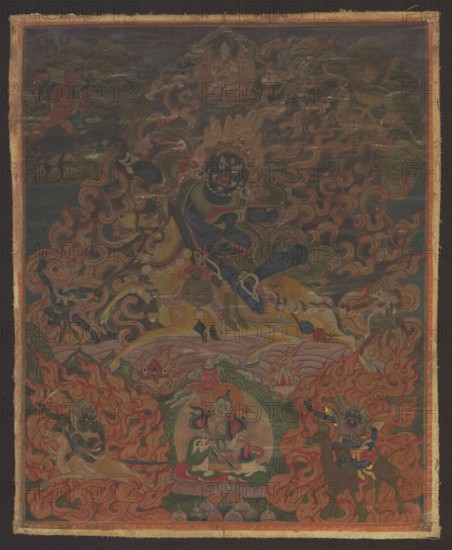 Palden Lhamo Sri Devi, Tibetan Buddhist art, Tibetan, painting thangka, depicting Goddess Palden Lhamo Tib. dpal ldan lha mo surrounded by acolytes: four demons, the guardian of heaven on a white lion holding an ichneumon in his left hand and an umbrella in his right — Kubera Skt. Vaishravana, Tib. rnam thos sras — and two zoocephalic dakinis: chu srin gdong ma Skt. Makaravaktra with the head of a Makara and seng ge'i gdong ma Skt. Simhavaktra with a lion head; iconography includes fire, flames, horses, skulls, demons, tantric Buddhist motifs, camels, fantastic creatures, wild boars, deer, lions, lotus throne, dharmapala. 19th century, Mongolia. Thangka scroll doublet; height 38 cm, width 31 cm., A richly detailed painted scene fills the image with a dominant central figure in dark blue surrounded by swirling flames and ornate patterns; the figure has multiple eyes and an elaborate headdress and sits astride a pale yellow horse. Around the central figure are several smaller figures, so...