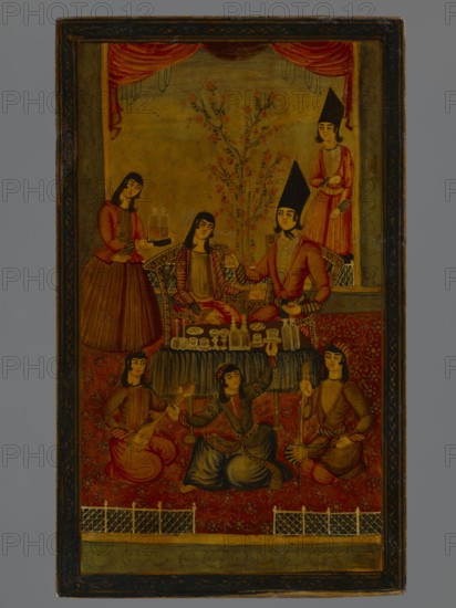 Mirror cover, Islamic art, Persian, Qajar dynasty 1785–1925; genre scenes: feasts, banquets, dances, music, musical instruments, dogs, wedding processions, candelabra, candles. a Depiction of a feast scene in an interior. b Depiction of a wedding ceremony in a courtyard. 2nd half of the 19th century, Iran; papier-mâché lacquered miniature; height 27.0 cm, width 16.2 cm., A painted scene shows a group of people gathered indoors with a patterned carpet and a decorative backdrop. Several seated figures wear red, pink, blue, and brown garments with patterned details and headwear; two figures wear tall black pointed hats. A central low table holds a variety of vessels and glassware in pale and transparent tones. A few standing attendants are positioned near the seated group, one holding a tray with covered items. Behind them a stylized flowering tree with pink blossoms rises against a yellowish background framed by red drapery at the top. The lower area features a red patterned carpet with ...