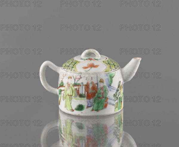 Teapot with lid, ceramics, figurative scenes, teapots, colored porcelain, Porcelain fragment; white, transparent glaze. Decoration painted with overglaze enamel paints and iron red. 19th century, China, vessel; height 8 cm, width 14.3 cm, diameter 9.3 cm, A small white porcelain teapot with a rounded body, a curved handle on one side and a short spout on the other, decorated with painted scenes of three seated and standing figures wearing robes and a few plants; the lid has a looped handle and painted floral and geometric motifs. The painted colors include green, orange, red, yellow, blue, and black on a white background, and the teapot sits on a reflective gray surface producing a mirrored reflection beneath it.