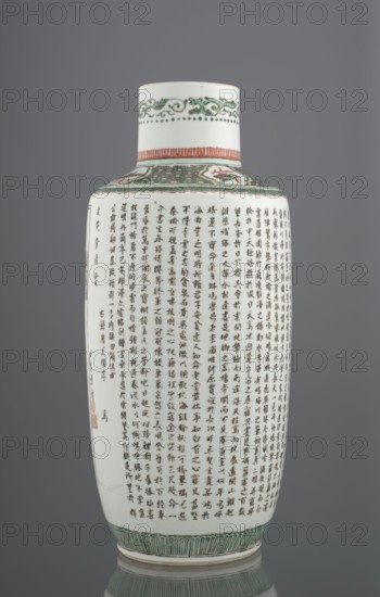 Vase, Chinese, Qing 1644–1911, ceramics; colored porcelain with landscape, architectural, and plant motifs; Bangping vase from the green family; cylindrical with a shortened neck on a wide, flat ring foot; decorated with the text by Wang Bo titled Prologue to the Poem on the Pavilion of Prince Teng and a landscape composition depicting the pavilion and its surroundings; 19th century, China; vessel; height 40.4 cm, diameter 17.8 cm, weight 2.7 kg., A tall ceramic vase with a cylindrical body and narrow neck standing against a neutral gray background; the vase surface is primarily white with a glossy finish and decorated with several bands of patterned ornament in green and reddish-orange near the neck and base, a group of dense vertical dark brushstrokes forming repeated columns across much of the body, and a few small red seals near the lower side; the top rim shows a decorative green scrolling motif and dotted border, the shoulder area has a green patterned panel with a small painted ...