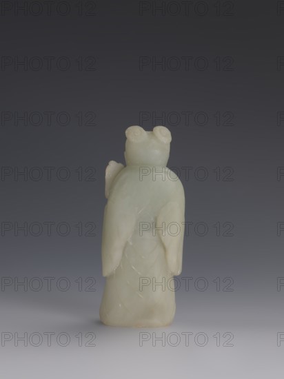 One of the Eight Immortals, Eight Immortals iconography, men, Chinese art, fans, Chinese culture, Qing 1644–1911, 19th century, China, sculpture, height 14.3 cm, width 5.9 cm, A pale greenish-white carved stone figure seen from the back, standing upright on a smooth surface against a dark gray gradient background; the figure has rounded shoulders, a smooth rounded head with two coiled shapes on top, draped sleeves that fall alongside the body, and a gently flared lower portion with faint carved curved lines suggesting layered shapes.