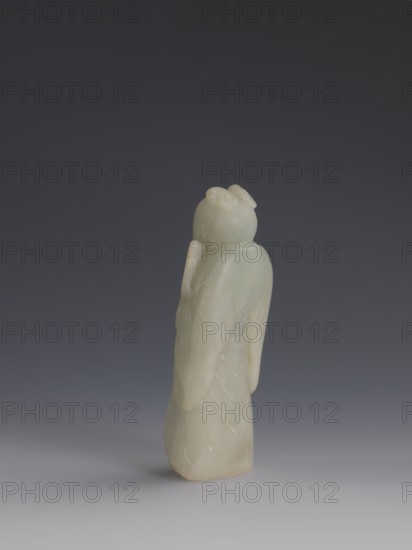 One of the Eight Immortals, Eight Immortals iconography, men, Chinese art, fans, Chinese culture, Qing 1644–1911, 19th century, China, sculpture, height 14.3 cm, width 5.9 cm, A pale green stone figurine stands upright against a dark gray to black gradient background, showing a smooth, rounded head with subtle carved hair details and a high bun, draped in flowing garments with carved folds and featherlike patterns; the stone has areas of whiter and slightly yellowish tones and a few small glossy spots, and the base rests on a lighter gray surface.
