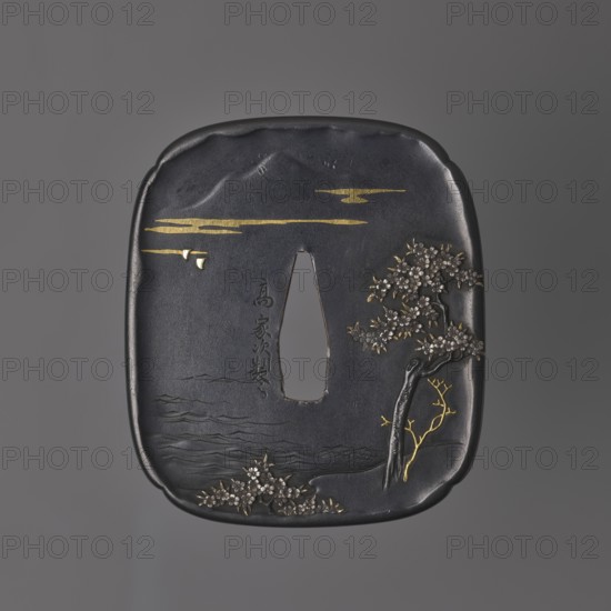 Crossguard tsuba, Takahashi Ietsugu fl. ca. 1830–1880. Tsuba in the shape of a rectangle with rounded sides with slight indentations in each corner sumi iri mokkô gata, slightly raised edge uchi kaeshi. Two-tone shield crossguard — obverse made of shakudo alloy, reverse of shibuichi. Decorated in high relief using inlay and engraving techniques: obverse shows a blossoming cherry tree standing on the seashore with a mountain peak silhouetted in the distance among clouds; reverse shows two swimming ducks and cherry blossom petals falling onto the water. Signature: Takahashi Ietsugu sei. 1st half of the 19th century Edo period, 1603–1868, Japan. Tsuba; height 7 cm, width 6 cm, depth 0.5 cm., A dark metallic square object with rounded corners sits against a gray background, featuring a central vertical oval opening. The surface shows a few raised and indented areas and fine engraved lines suggesting rippling water near the bottom. A group of small floral clusters appears at the lower edge ...
