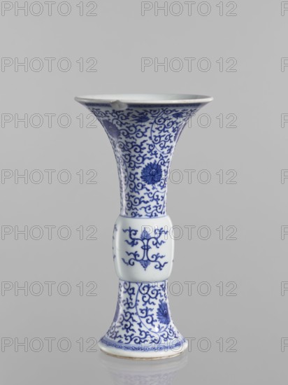 Gu-type vase, blue-and-white porcelain, Qing dynasty 1644–1911, early 19th century, Chinese, decorated with lotuses and lotus tendril ornament, backdated signatures, vessel, height 22.6 cm, diameter 12.2 cm, A slender porcelain vase with a flared rim and a narrow waist, decorated in blue on a white ground with intricate scrolling floral and vine motifs, a few stylized flowers, and a raised rectangular midsection with additional blue decorative patterns; colors visible include white and shades of blue, and the background is a neutral pale gray.