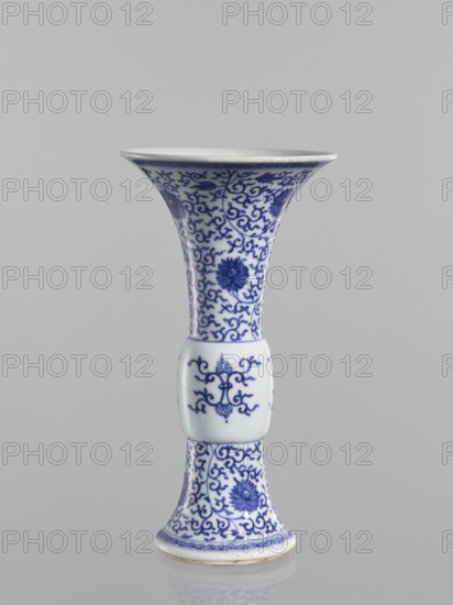 Gu-type vase, ceramics, Qing style, blue-and-white porcelain, Chinese art, Chinese culture, lotuses, lotus tendril ornament, Qing 1644–1911, backdated signatures, early 19th century, China, vessel, height 22.6 cm, diameter 12.2 cm, A tall, flared porcelain vase with a bulbous midsection, decorated in blue floral and scrolling vine patterns on a white background, standing against a neutral gray backdrop; the top and bottom rims show thin blue border motifs and the surface displays detailed blue flowers and curling tendrils.