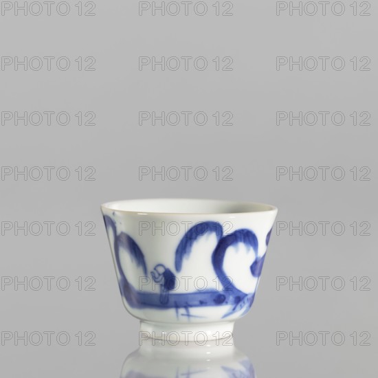 Bowl, ceramics, blue-and-white porcelain, Qing style, Chinese, landscape with architecture and staffage motifs, 19th century Qing dynasty, 1644–1911, porcelain pottery, grayish-white. Bowl with flared edges on a low ring foot; height 4.4 cm, diameter 5.8 cm., A small white ceramic cup with a glossy finish sits against a plain light gray background, decorated with a blue painted design that wraps around its exterior showing sweeping curved brushstrokes and a few small rounded shapes, the rim is slightly flared and the base narrows into a short foot, the surface reflects light creating subtle highlights.