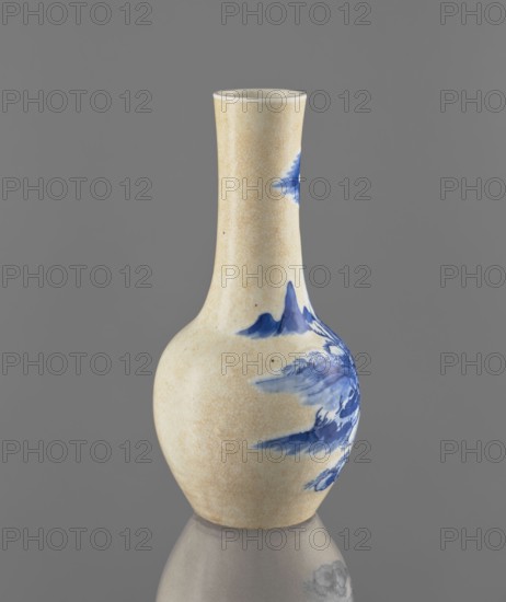 Vase, Chinese, Qing dynasty 1644–1911, 19th century. Blue-and-white porcelain with cracklework decoration depicting fishermen and landscape motifs. Vessel; height 23.9 cm, diameter 11.7 cm, weight 0.7 kg., A ceramic vase with a narrow neck and rounded body sits against a plain gray background, showing a crackled cream-colored glaze overall and blue painted floral and landscape motifs on one side; the vase casts a subtle reflection on the surface beneath it and displays visible glaze texture and slight surface spotting.