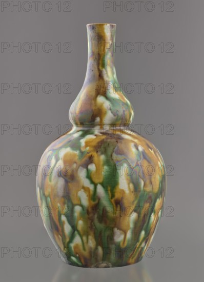 Gourd-shaped vase, maker,  from Ignacy Jan Paderewski 1860–1941; Chinese art, Chinese; Qing dynasty 1644–1911, 18th century, China; vessel; height 19.1 cm, diameter 10.8 cm, weight 0.4 kg., The image shows a glossy ceramic vase with a narrow neck and a bulbous body, covered in a mottled, drippy glaze featuring a mix of green, gold, white, brown, and iridescent purplish tones, set against a plain gray background.