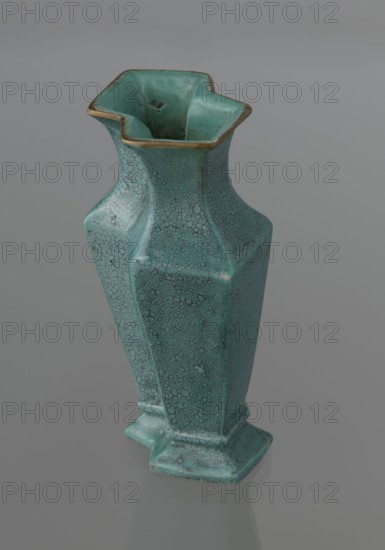 Vase, gift, Qing style, ceramics, Chinese art, Chinese culture, Qing dynasty 1644–1911, 19th century, China; vessel; height 11.6 cm, width 4.7 cm, depth 7.15 cm., A tall hexagonal vase with a flared, scalloped rim sits on a reflective surface; the vase is predominantly turquoise with a crackled darker turquoise and teal speckled pattern and has areas of darker greenish turquoise patina and brownish edges, including a thin brownish-golden trim along the rim.