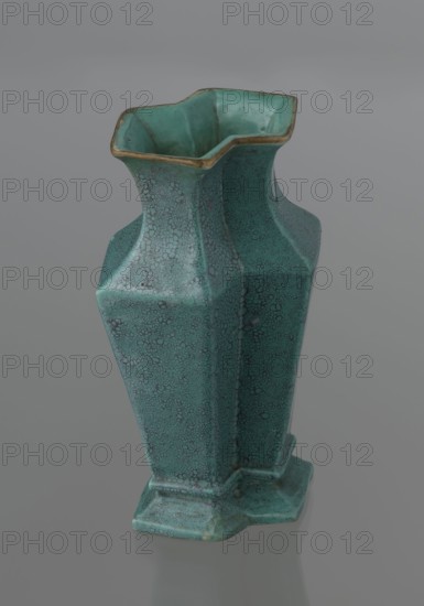 Vase, Qing style, ceramics, Chinese, Qing 1644–1911, 19th century, China; vessel; height 11.6 cm, width 4.7 cm, depth 7.15 cm., A tall ceramic vase with a hexagonal, faceted form and a flared, undulating rim, glazed in turquoise and teal tones with a speckled crackle pattern and a thin band of golden-brown along the lip, standing on a matching hexagonal base on a neutral gray background.