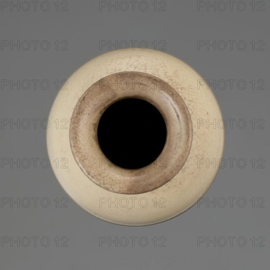 Cylindrical porcelain vase tapering toward the bottom with a flat rim; light cream glaze with fine cracklework. Wooden round flat saucer on three legs. 19th century, Japan; ceramics; Japanese Edo period. Vessel. Height 21.1 cm; diameter 8.4 cm; weight 0.6 kg., A round vessel viewed from above with a dark central opening surrounded by a rim in shades of brown and beige, the body of the vessel in a creamy off-white with fine crackle patterns, set against a uniform gray background; visible colors include black, brown, beige, creamy off-white, and gray.