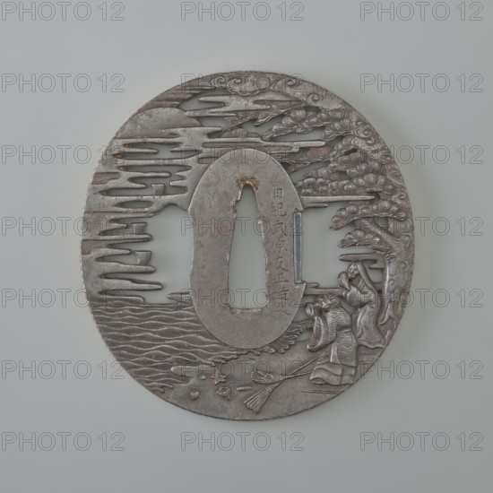 Crossguard tsuba, Takehara Tomomasa; oval tatemaru gata tsuba with rectangular edge, inlaid with gold using the nunome technique in a rinzu ornament. Side holes ryôhitsu ana are part of the openwork background. Decorated in relief carving and engraving with a mythological scene: two elderly people standing by the seashore beneath a spreading pine tree, gazing at the moon emerging from fog and folding their hands in prayer; two brooms and several shells lie on the shoreline sand. The male figure is Jô, son of Izanagi, who met and married Uba in Takasago; after death their spirits inhabited pine trees and meet on moonlit nights, sweeping pine needles onto the beach—symbolizing long life and a happy marriage. Japanese, 18th century Edo period, 1603–1868. Medium: metal tsuba; height 7.0 cm, width 6.7 cm, depth 0.45 cm., A round metallic object with a central oval opening and a vertical slit, rendered in shades of silver and gray with areas of darker patina, showing a carved scene with styl...