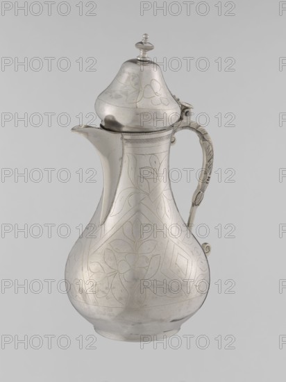 Teapot with a lid, Islamic art, Turkish, Ottoman dynasty 1299–1922, 19th century, Turkey; vessel used for beverages teapot; materials/technique unspecified; geometric motifs and plant ornament; weight 300 g; height 20.3 cm; diameter 9.7 cm., A metallic pitcher with a rounded body, narrow neck, and domed lid topped by a small finial sits against a plain light gray background; the pitcher is silver in color with etched floral and geometric patterns covering its surface, and it has a curved spout and an ornately decorated handle with textured detailing that attaches near the top and middle of the body.
