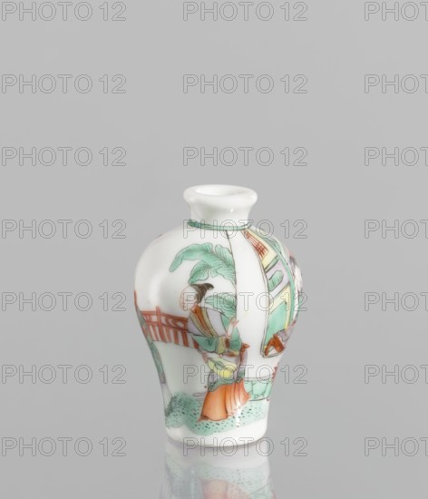 Flask - Snuffbox. A baluster-shaped flask, significantly widened at the shoulders, decorated with a fragment of landscape and architecture slightly highlighted in the decoration. Thick white porcelain body. 18th century, China. Colored porcelain, figurative scenes, images of women. Vessel snuffbox, height 7 cm, diameter 4.7 cm., A small porcelain vase with a rounded body and narrow neck sits against a plain light gray background; the vase is predominantly white with painted scenes in green, orange, red, light blue, brown, and black, showing a figure wearing orange and green garments standing near a railing and foliage rendered in green, with architectural elements in green and red on the curved surface, and the glaze gives a glossy finish with a faint reflection visible beneath the vase.