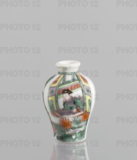 Flask - Snuffbox, Chinese, 18th century. A baluster-shaped colored porcelain flask/snuffbox, significantly widened at the shoulders, with a fragmentary landscape and architectural scene and images of women in the decoration. Thick white porcelain body white cake. Height 6.9 cm, width 4.6 cm., A small ceramic vase with a rounded body and narrow neck sits against a plain light gray background, the vase decorated with a painted scene showing a seated figure wearing a dark hat and green clothing inside an architectural frame, surrounded by stylized plants and foliage in shades of green and orange, with additional decorative bands and panels in pale yellow, light purple, and green; the vase surface is glossy and reflects softly onto the surface beneath it, and the overall color palette includes white, green, orange, pale yellow, light purple, dark brown, and gray.