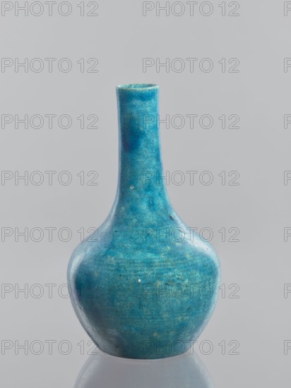 Vase-bottle;, ; Chinese; Qing dynasty 1644–1911; glazed crackleware ceramic vessel; 19th–20th century; height 18.4 cm, diameter 10.8 cm, weight 0.35 kg., A single ceramic vase with a narrow neck and a rounded base sits against a plain background, displaying a mottled turquoise and teal surface with variations of blue and hints of green, a glossy finish, and subtle darker and lighter speckling across its body.