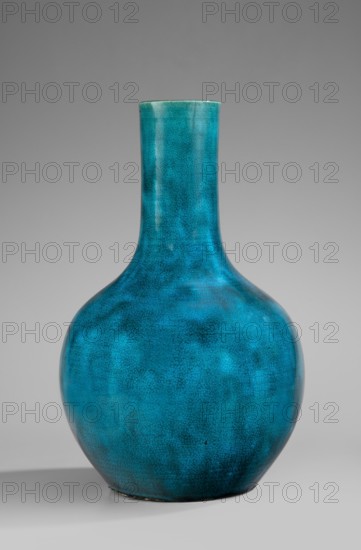 Bottle-shaped vase, Chinese, Qing dynasty Kangxi period, 1662–1722, 17th/18th century; porcelain vessel, height 30.5 cm., A rounded ceramic vase with a long narrow neck sits against a plain background; the vase is predominantly turquoise with variations of blue and teal creating a mottled, crackled surface texture and subtle darker patches, and the background is shades of gray.