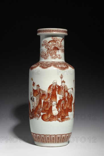Vase, Luohan iconography; porcelain; arhat iconography; ceramics; Qing style; dragons iconography; colored porcelain; Chinese culture; Qing dynasty 1644–1911; Qianlong period/style 1736–1795. Vase with a cylindrical neck, decorated on the belly with figures of Arhats and a lambrequin ornament, and on the neck with a dragon with a pearl among clouds. Signed. Date: 1736–1795. Origin: China. Vessel. Height: 45 cm; diameter: 17.5 cm., A tall porcelain vase with a long neck and flared rim sits against a dark background; the vase is primarily white with a reddish-brown painted decoration that includes a group of robed human figures gathered around a seated, smiling figure, ornate cloud-like patterns near the neck, and decorative bands around the rim and base.