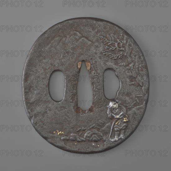 Crossguard tsuba, Kaneie craftsman, 18th century Edo Period, 1603–1868, Japan; Fushimi, Yamashiro province. Oval tsuba tatemaru gata with rounded edge maru mimi; height 8.0 cm, width 7.4 cm, depth 0.4 cm. Both sides decorated in relief landscape with figures: obverse shows a wanderer with two calabashes at his belt and a stick standing by a mountain stream — details face, hands, bottles, binding inlaid with silver, gold, and copper; reverse depicts a fisherman in a boat by a bamboo-covered shore with minor accents inlaid with gold. Subjects: landscape motifs, rocks, trees, bamboo, water, fishermen, boats, sea waves; weapon type: sword crossguard tsuba for katana., A round, dark brown metal object with a textured surface and a few areas of lighter gray patina, featuring a central elongated opening flanked by two oval openings; near the lower right edge there is a small, raised figure in silvery-gray with darker brown accents and touches of gold on small details, and a raised rocky forma...