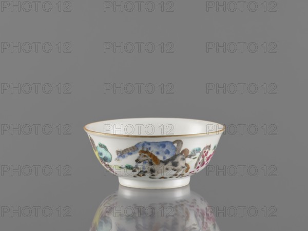 Bowl, ceramics, colored porcelain, landscape motifs, Qing style, Chinese art/culture, horses, bowl on a ring-shaped foot, decorated on the outer wall, 19th century Qing 1644–1911, China; vessel; height 4.8 cm, diameter 11.7 cm., A shallow porcelain bowl sits on a reflective surface against a plain gray background, the bowl showing a white interior and an exterior band decorated with painted animals and floral motifs; the rim has a thin gold edge, and the painted designs include horses in shades of gray, brown, and blue, foliage in green and teal, and flowers in pink and yellow, with the reflection of the bowl visible below.