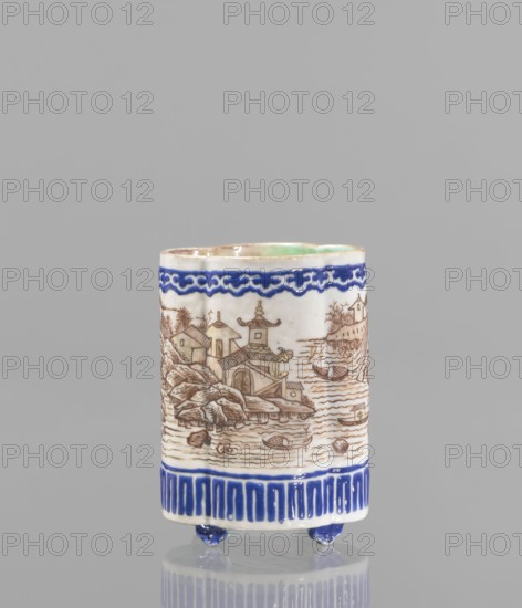 Bowl for tablecloths, ceramics, colored porcelain, fishermen, Chinese art, Qing style, landscape motifs, Chinese culture, incense, geometric ornaments, lambrequin pattern, containers, provenance noted, Qing 1644–1911, Qianlong 1736–1795, Qianlong style, backdated signatures. Bowl on four small feet. Continuous landscape decoration, bordered at the top and bottom with geometric and lambrequin ornament. 19th century, China, bowl, height 8.2 cm, diameter 6 cm., A cylindrical ceramic vessel standing on a group of small rounded feet, decorated with a hand-painted landscape scene in brown lines on a white ground, showing buildings with tiered roofs, boats on water, rocky shoreline, and vegetation; the rim and lower border feature decorative bands in deep blue with a wave-like motif at the top and a vertical stripe pattern at the bottom, and the interior rim shows a pale green glaze; visible colors include white, brown, deep blue, pale green, and a hint of tan.