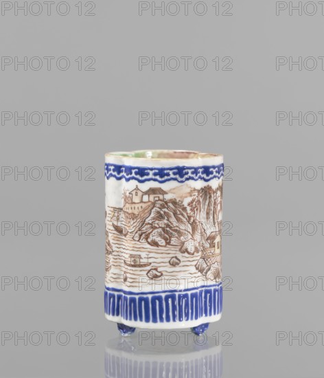 Bowl for tablecloths, ceramics, colored porcelain, fishermen, Chinese art, Qing style, landscape motifs, Chinese culture, incense, geometric ornaments, lambrequin pattern, containers, revindication provenance, Qing 1644–1911, Qianlong 1736–1795, Qianlong style, backdated signatures. Bowl on four small feet. Continuous landscape decoration, bordered at the top and bottom with geometric and lambrequin ornament. 19th century, China. Bowl, height 8.2 cm, diameter 6 cm., A cylindrical ceramic vessel standing on a reflective surface with a plain gray background, decorated with a hand-painted landscape scene in brown tones around the middle, a decorative band of deep blue near the top and a patterned blue band near the base, small blue feet under the base, and a pale greenish interior rim; visible colors include white, brown, deep blue, pale green, and gray.
