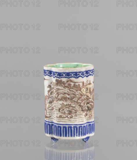 Bowl for tablecloths, ceramics, colored porcelain, fishermen, Chinese art, Qing style, landscape motifs, Chinese culture, incense, geometric ornaments, lambrequin pattern, containers, revindication provenance, Qing 1644–1911, Qianlong 1736–1795, Qianlong style, backdated signatures. Bowl on four small feet. Continuous landscape decoration, bordered at the top and bottom with geometric and lambrequin ornament. 19th century, China. Bowl, height 8.2 cm, diameter 6 cm., A cylindrical ceramic vessel standing on small rounded feet, primarily white with blue decorative bands near the top and bottom, and a pale green glazed interior; the exterior shows a detailed brown line landscape scene with rocks, trees, buildings, and water, and the lower blue band features a vertical repeat pattern while the upper blue band has a wavy motif.