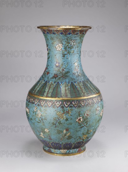 Vase, Chinese, Qing 1644–1911, 18th/19th century. Porcelain vessel with a thick cylindrical neck and flared spout; decorated with chrysanthemums, peonies, plum trees, meander ornament and plant motifs. Height 61.5 cm; diameter 25.7 cm; weight 10.0 kg., A rounded, bulbous vase with a flared neck sits against a plain neutral background; the vase is predominantly turquoise with intricate darker turquoise textured patterning and features floral motifs in white, red, yellow, green, and blue, with leafy green stems and accents of gold around the rim and bands; a band of stylized scallop and heart-like shapes in deep blue and purple encircles the shoulder, and a row of vertical feather-like green elements decorates the upper body; the base area shows deep blue panels with gold details and the overall surface has an enamel-like finish.