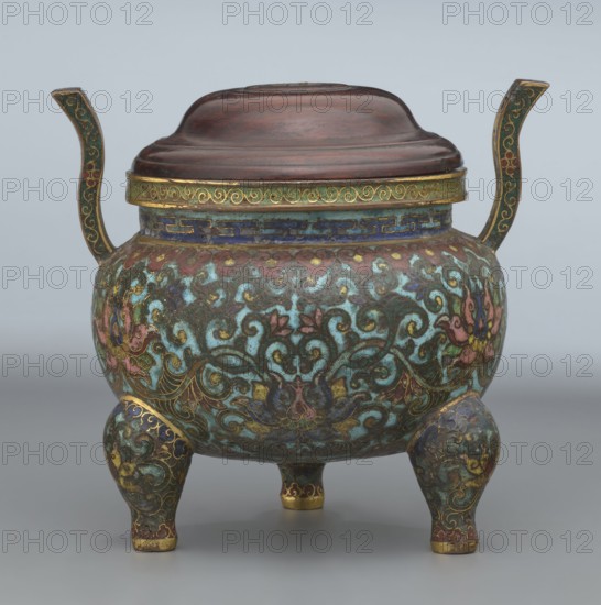 Ding-type incense burner with cover; maker, Chinese; Qing dynasty, Qianlong period 1736–1795; ceremonial ding vessel/censer decorated with lotus plant ornament; inscribed/provenance: Paderewski, Ignacy Jan 1860–1941 noted; incense burner; height 11.5 cm, diameter 11.0 cm., A rounded lidded vessel with two upward-curving handles and three short bulbous legs, decorated all over in swirling floral and foliate patterns. Predominant colors visible are turquoise, dark teal, blue, pink, purple, green, gold, brown, and hints of red. The lid appears to be a smooth dark brown with subtle concentric contours, while the rim has a gold band with a decorative motif. The body shows an intricate enamel-like surface with scrolling vines, stylized flowers, and layered color fills, with gold outlining and accents. The handles are dark green with gold detailing, and the legs echo the same multicolored decorative scheme with gold trim at the feet. The overall surface has a slightly aged patina and a glossy...