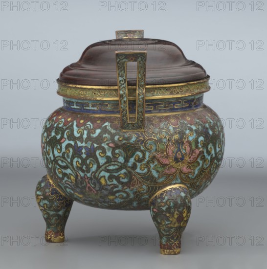 Ding-type incense burner with cover, Chinese, Qing dynasty, Qianlong period 1736–1795. Bronze ceremonial ding vessel/censer with plant ornament lotuses. Incense burner, height 11.5 cm, diameter 11.0 cm., A rounded tripod vessel with a domed lid and a vertical rectangular handle, decorated all over in swirling floral and foliate patterns; visible colors include turquoise, green, dark blue, gold, pink, red, brown, and touches of black and yellow; the lid appears dark brown with a small rectangular finial, the rim is bordered with gold and blue bands, the body shows ornate scrolling vines and stylized flowers in turquoise and green with gold outlines and pink and red accents, and the three short rounded legs repeat the same decorative motif and colors.