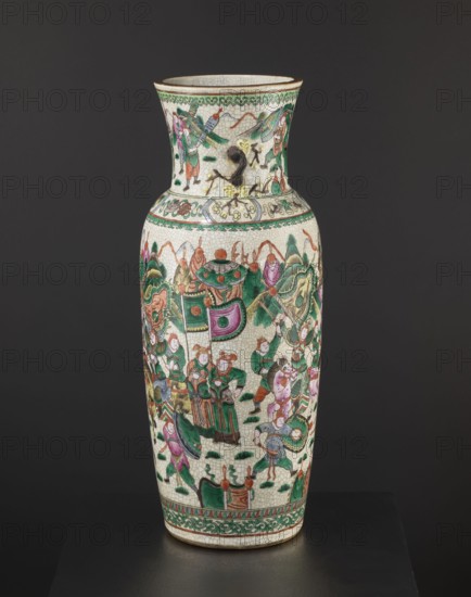 Vase, noted. Chinese, 19th century. Colored porcelain vessel, height 61 cm, diameter 19.6 cm. Slightly tapering toward the bottom with a thick neck slightly flared upward and two small handles shaped like a plum blossom branch. Body decorated with an elaborate battle scene of warriors on foot and on horseback; neck shows a dignitary surrounded by her entourage. Features figurative scenes, plant ornaments, horses, warriors, landscapes, and battle scenes., A tall ceramic vase with a crackled off-white surface decorated with ornate painted scenes in green, pink, red, orange, brown, black, and yellow hues; the vase has a flared neck and a rounded body with a decorative band near the top and bottom featuring green and brown patterns, and the main body shows a group of stylized figures and ornamental motifs, some wearing green and pink garments, surrounded by foliage-like shapes in green and brown, curved decorative elements in pink and green, and small ground accents in dark green, with a p...