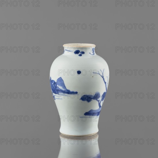 Meiping-type vase, ceramics, Meiping vessel type, blue-and-white porcelain, Qing style 1644–1911, landscape motifs including rocks, trees, and a pagoda; neck decorated with small plant motifs, Chinese, 1662–1722, vessel, height 17.7 cm, diameter 11.8 cm, A white ceramic vase with a rounded body, a slightly narrowed neck, and a small flared rim sits against a grey background; the vase features blue painted landscape motifs including stylized mountains, a tree with bare branches, and abstract cloudlike or foliage shapes, with decorative blue dots and brushstrokes near the neck and scattered on the body; the rim and base show a faint beige tint, and the overall visible colors are white, blue, beige, and grey.