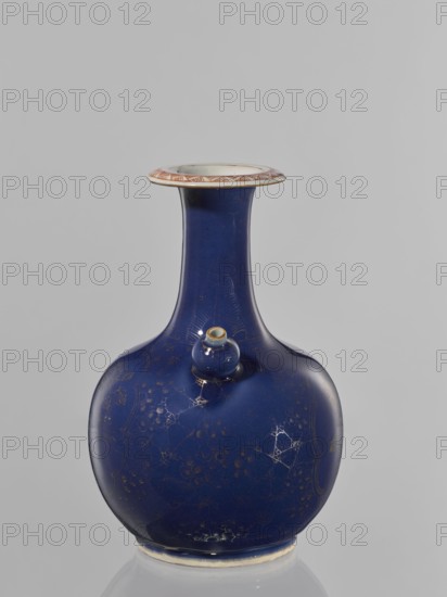 Kendi vessel, Artemisia, bottles, ceramics, floral pattern, Chinese art, Qing style, colored porcelain, Chinese culture, kendi, reclaimed provenance, Qing 1644–1911. Bulbous bottle with a long neck and a flared spout; the second spout is bell-shaped on the collar. Border features flowers against a spiderweb background, and artemisia leaves on the neck. 18th century, China. Vessel; height 23.7 cm, diameter 16 cm., A glossy deep blue ceramic vase with a rounded body and a long narrow neck, showing a small rounded protrusion on the shoulder; the vase surface has faint decorative patterns and subtle crackle-like lines, and the rim flares outward with a pale top edge featuring a patterned band in reddish-brown and white; the base shows a thin unglazed band in an off-white color, and the background is a flat light gray.