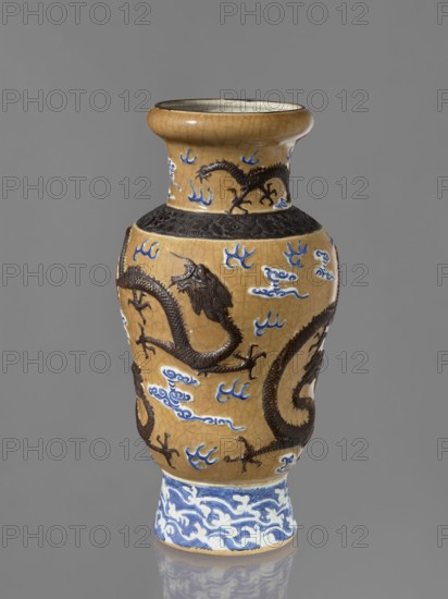 Vase, Chinese, 19th century. Steam vase; ovoid; short, slightly flared foot; pear-shaped belly; neck bulging at the rim. Decorated with dragons, clouds, flames, cracklework, and geometric ornaments. Ceramics. Height 43.6 cm; diameter 15 cm; provenance includes repossession., A ceramic vase with a glossy finish in tan and brown tones, featuring a bulbous body, narrowed neck, and flared rim, decorated with raised dark brown dragon motifs wrapping around the surface and stylized cloud-like shapes in blue and white; the base section has a band of swirling blue and white patterns, and there is a textured dark brown band around the shoulder. The overall colors visible are tan, dark brown, blue, white, and a bit of gray on the interior rim, set against a neutral gray background.
