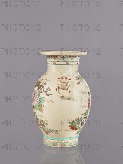 Vase, flowers, satsuma, Japanese art, vases, Japanese culture, ceramics, cracklework decoration, lions, floral decorations, peonies, chrysanthemums, plum trees, Meiji 1868–1912, ca. 1870–1880 Meiji 3–13, Japan, vessel, height 26.5 cm, width 17.5 cm, diameter 16.5 cm, A ceramic vase with a rounded body and a flared rim sits against a plain gray background, predominantly cream in color with decorative floral painting in green, pink, red, and blue, and small gold or brown dotted accents. The rim has a band of turquoise and red petal-like motifs, and the neck area shows thin green bands. A sculpted lion head with a ring is attached to the front of the vase in the same cream tone with small red accents. The main body features painted branches with leaves and blossoms in shades of green, pink, and red, along with brown stems and subtle gold or brown dotted cloud-like marks. The base has a turquoise band above a patterned border in turquoise, cream, and red. The surface shows a glossy finish ...